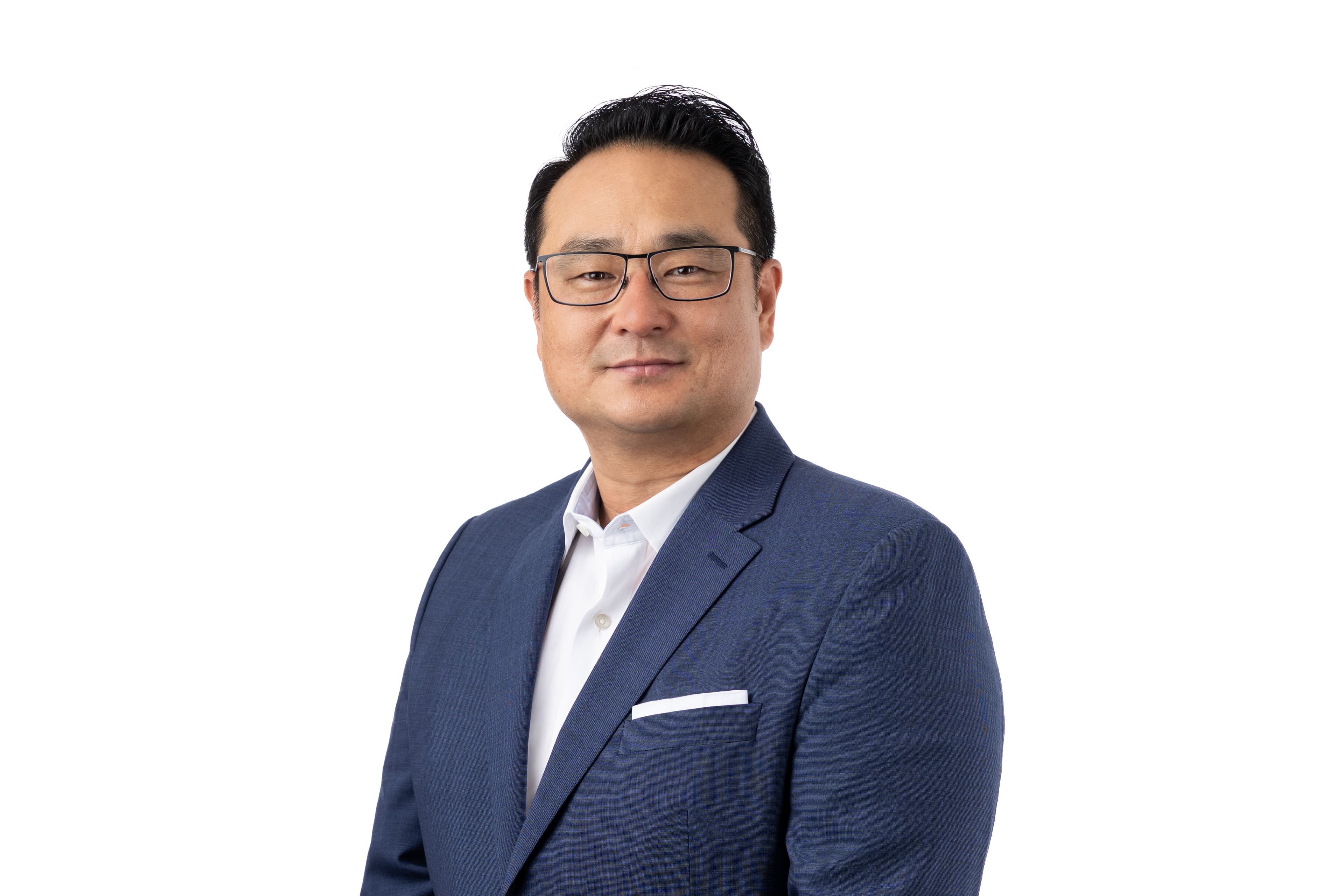 East Asian man with glasses wearing a blue blazer and white shirt on white background.